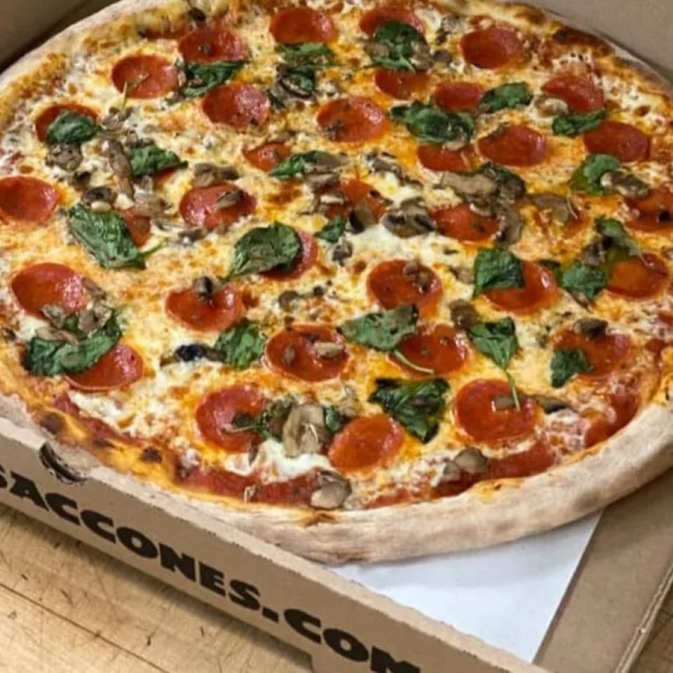 A large Saccone's pizza with pepperoni, mushrooms, and spinach in a cardboard box.